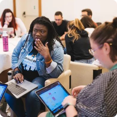 Beefree employees on their laptops on team retreat